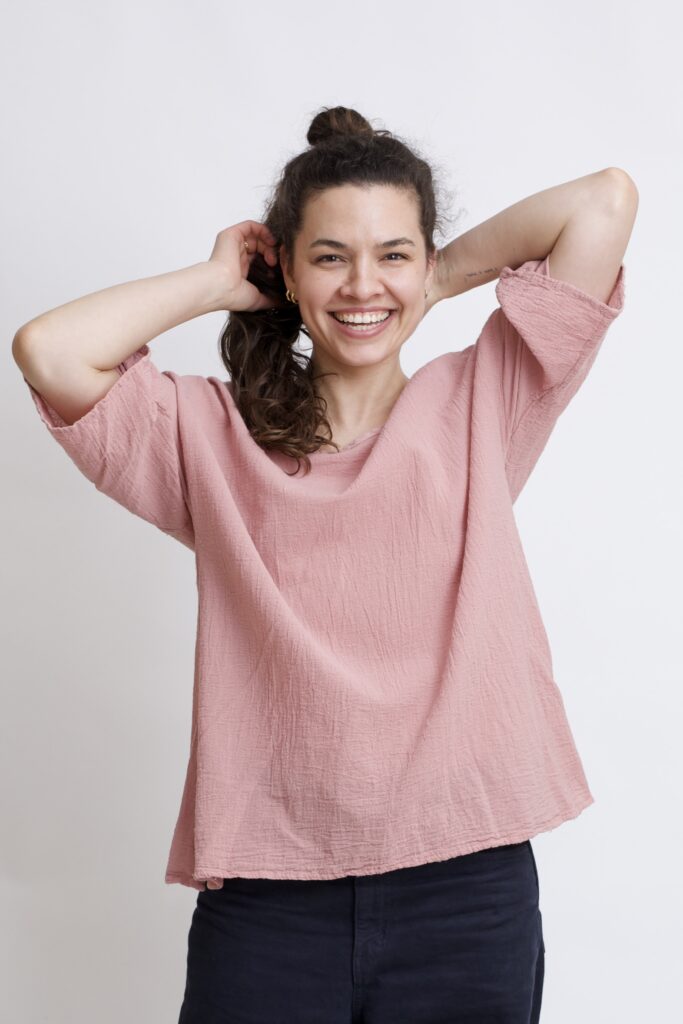 damska bluzka oversize. Modelka w luźnej bawełnianej bluzce w kolorze róż pudrowy
